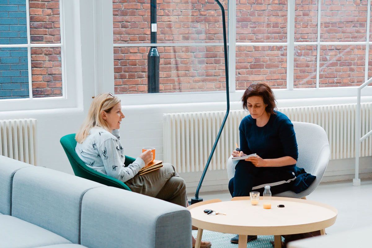 Two Women Sitting In An Office Two Women Sitting In An Office